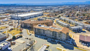 Aerial Exterior of Sable ridge apartments, parking lot, and surrounding areas, photo taken on a sunny day.